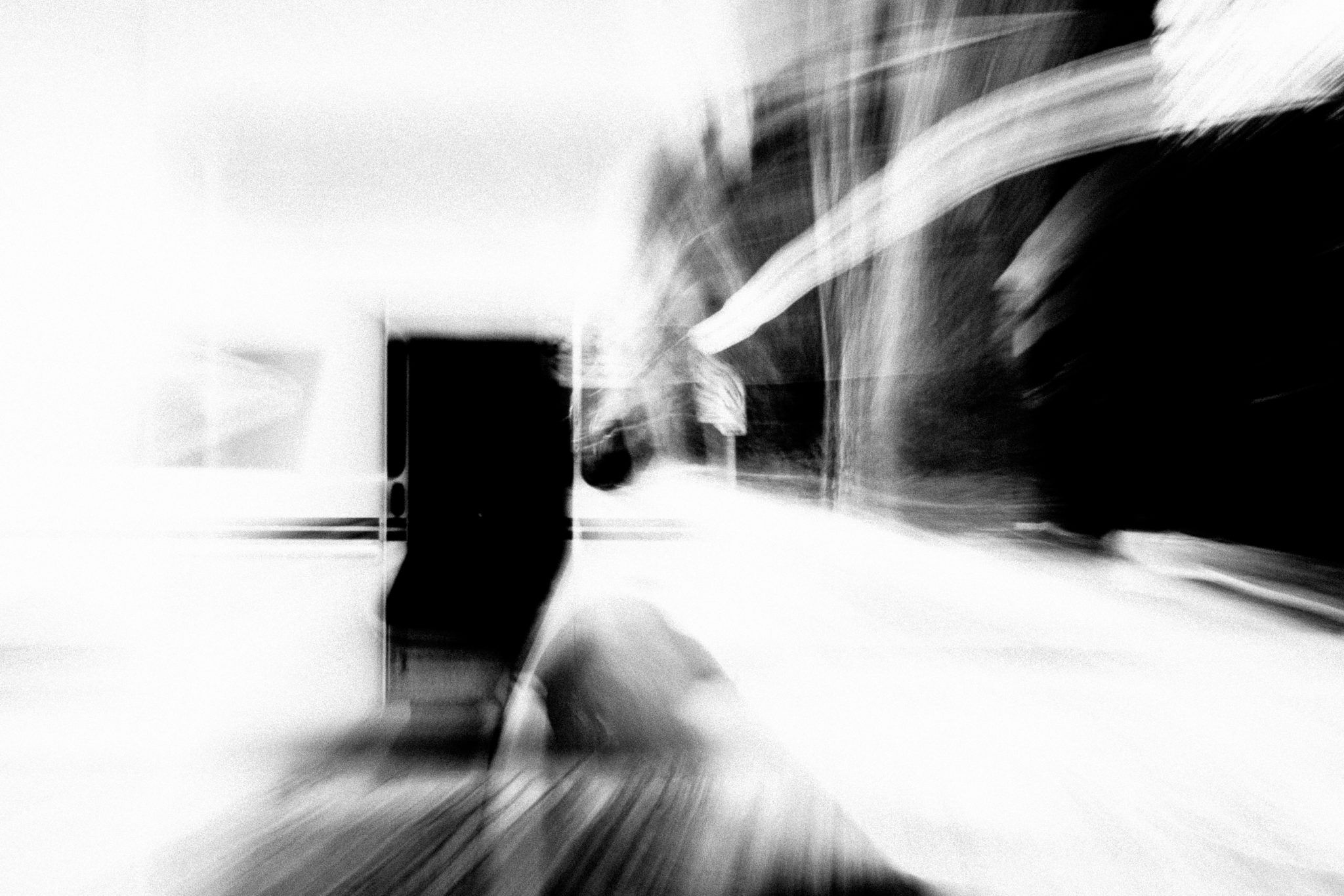 A black and white image shot by Jay Sennett of postal truck with a very blurry vortex achieved by pulling focus.