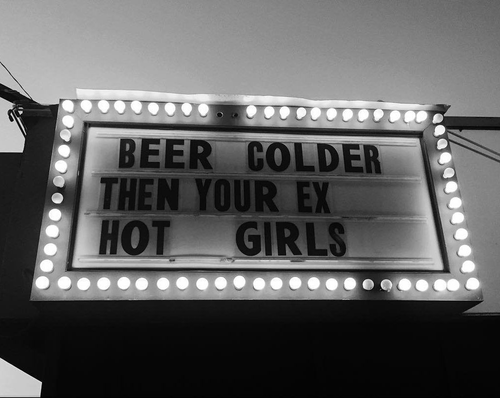 A neon sign reads beer colder then your ex. hot girls