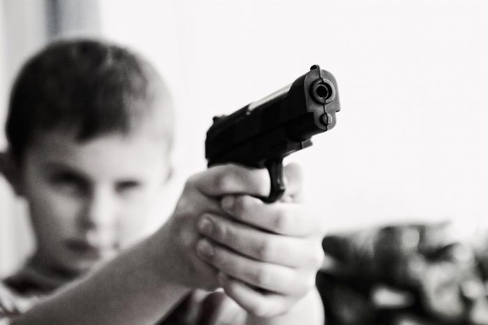 A child holds a pistol