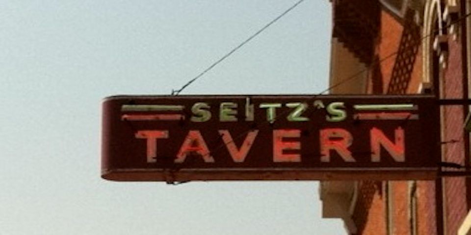 A color photo of the neon sign of Seitz’s Tavern