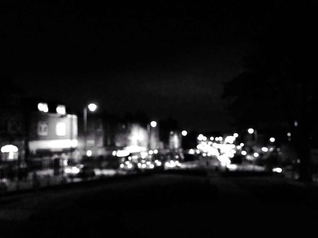 A black and white photo of a city that is blurred.