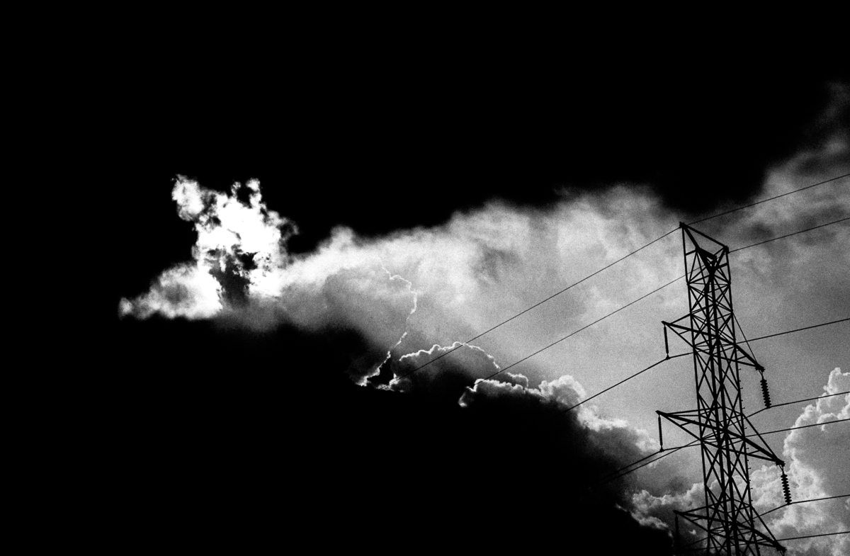Storm clouds open up in front of a power line. Shot with a Canon 60D by Jay Sennett