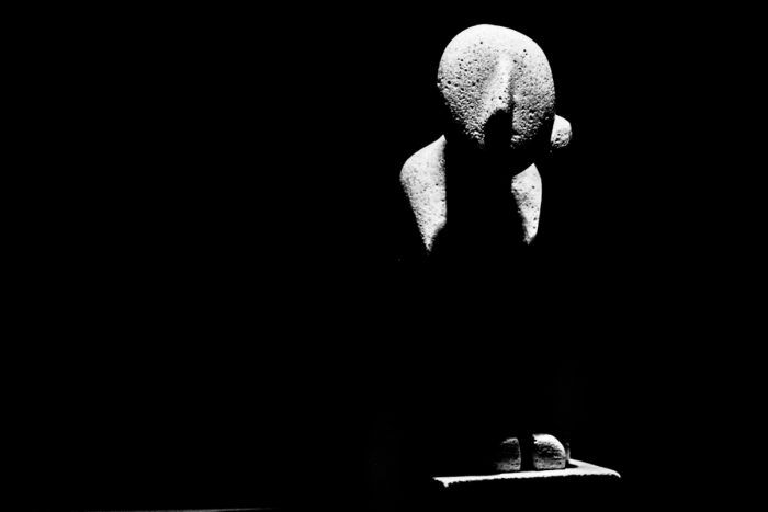 A statue sits bathed in light surrounded by darkness. Shot with a Canon 60D by Jay Sennett